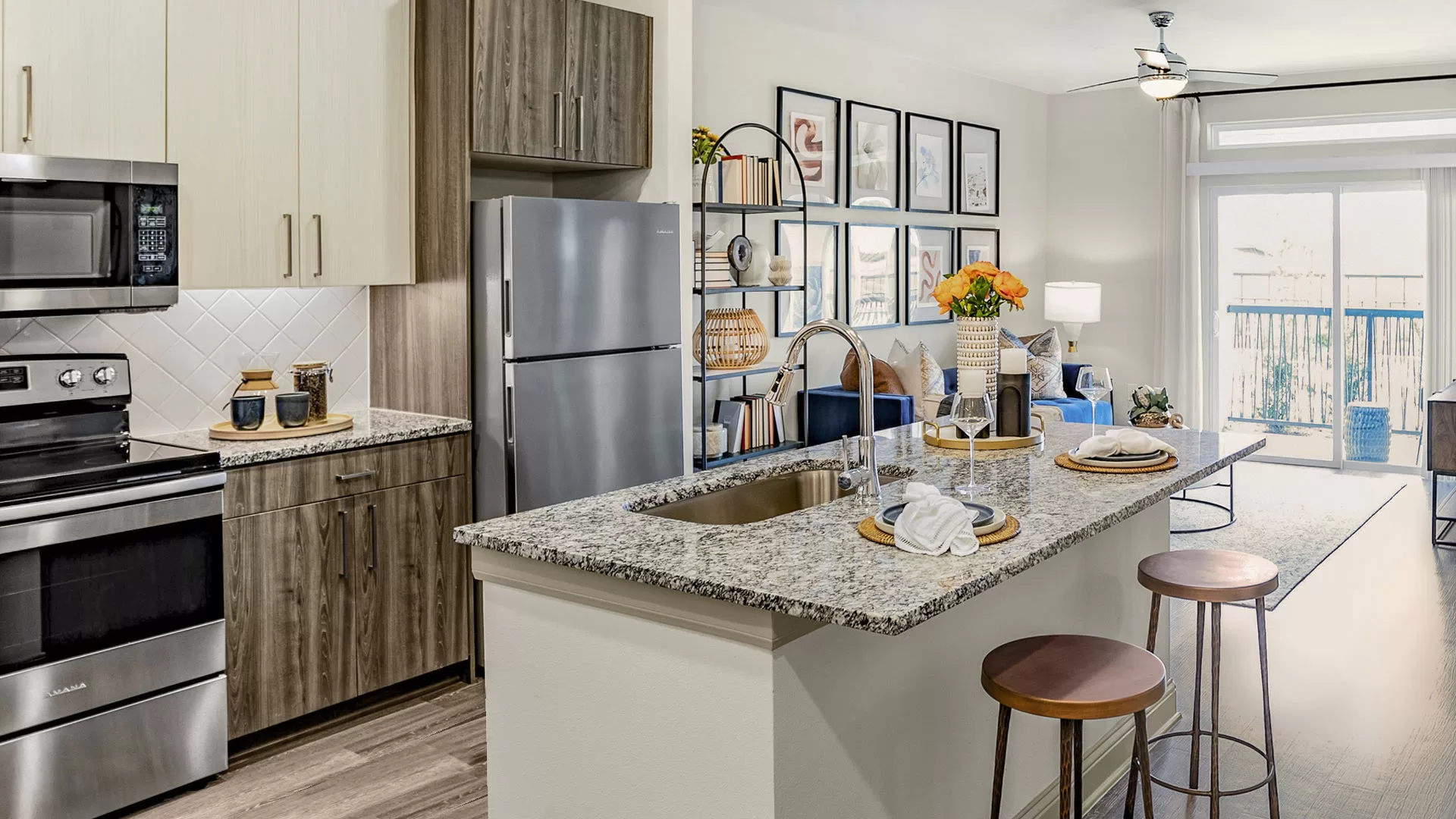 Kitchen with island and stainless steel appliances at our Huntsville, TX apartments at the Domain.